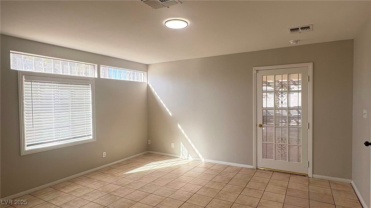 7113 Pinelake Road Las Vegas, NV 89145 - Photo 16 of 22 Spare room with light tile patterned floors and baseboards
