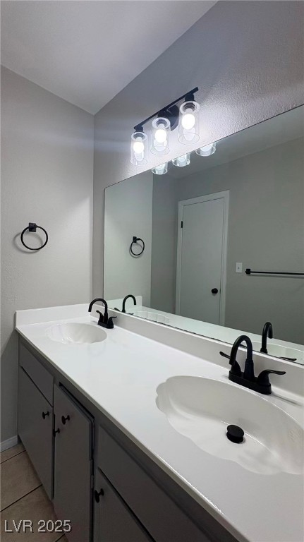 7113 Pinelake Road Las Vegas, NV 89145 - Photo 18 of 22 Full bathroom with double vanity and light tile patterned floors
