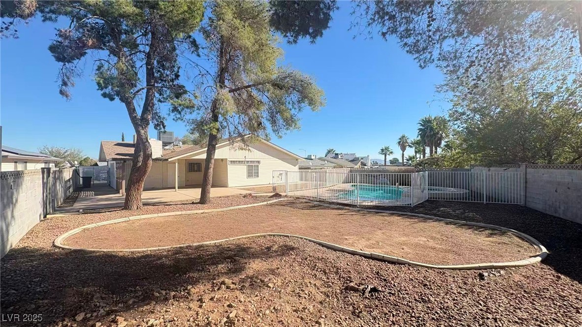 7113 Pinelake Road Las Vegas, NV 89145 - Photo 20 of 22 Fenced backyard with a patio area
