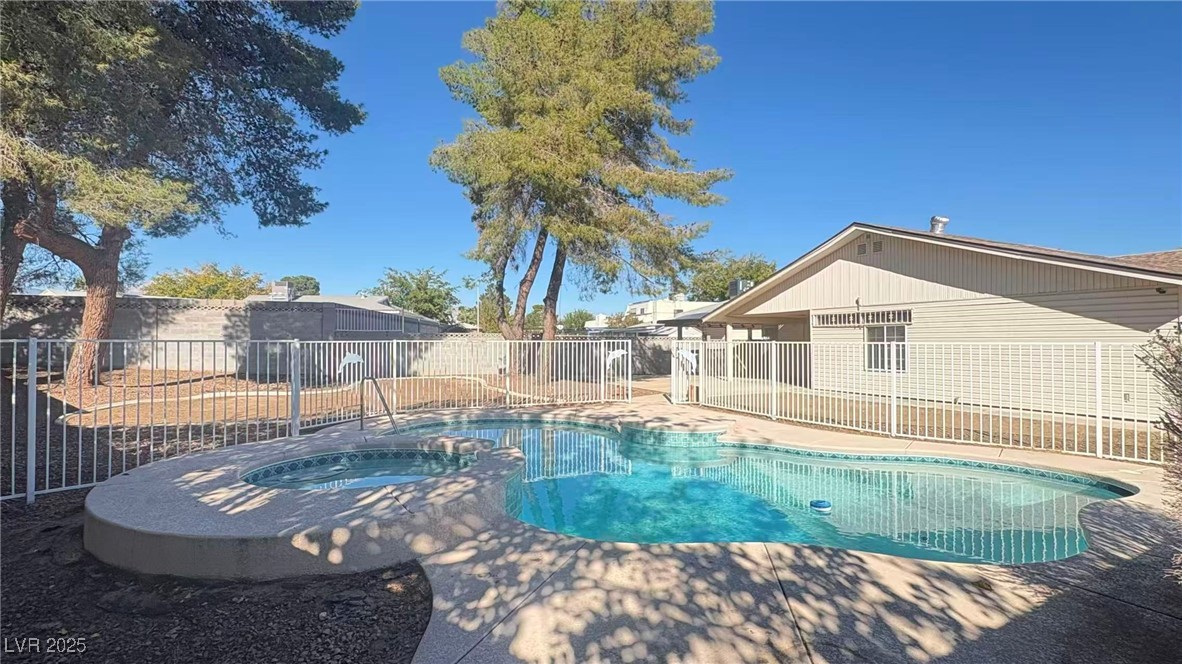 7113 Pinelake Road Las Vegas, NV 89145 - Photo 21 of 22 View of swimming pool with a fenced backyard, a pool with connected hot tub, and a patio