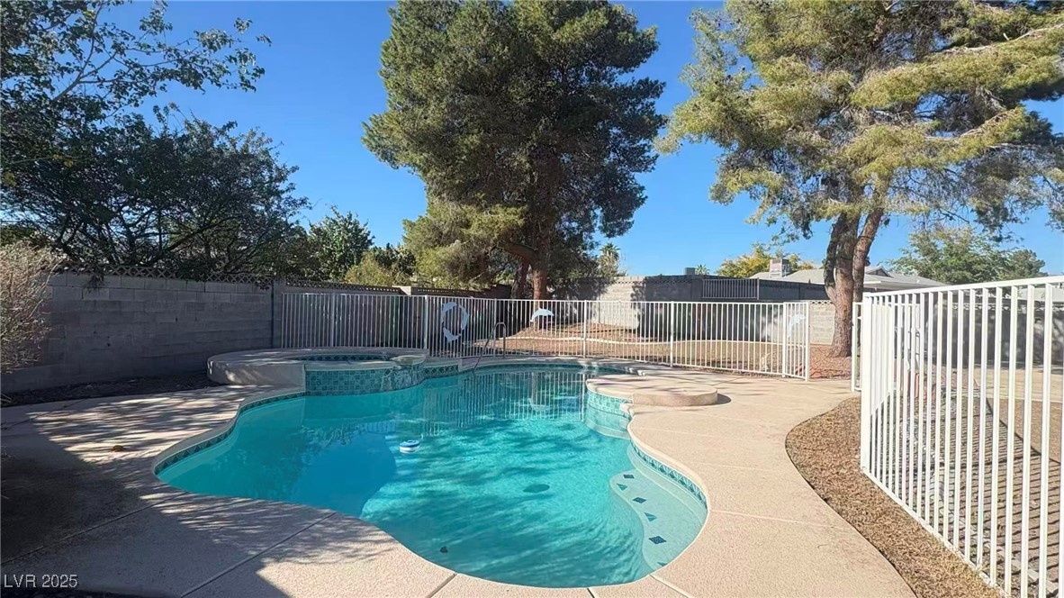 7113 Pinelake Road Las Vegas, NV 89145 - Photo 22 of 22 View of pool featuring a fenced backyard, a patio, and a pool with connected hot tub