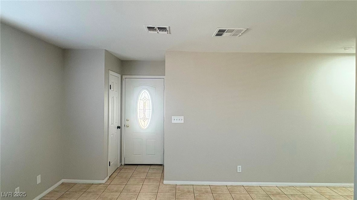 7113 Pinelake Road Las Vegas, NV 89145 - Photo 7 of 22 Foyer entrance with light tile patterned floors and baseboards