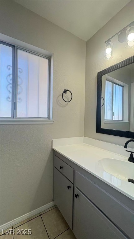 7113 Pinelake Road Las Vegas, NV 89145 - Photo 9 of 22 Bathroom featuring vanity, light tile patterned flooring, and a textured wall