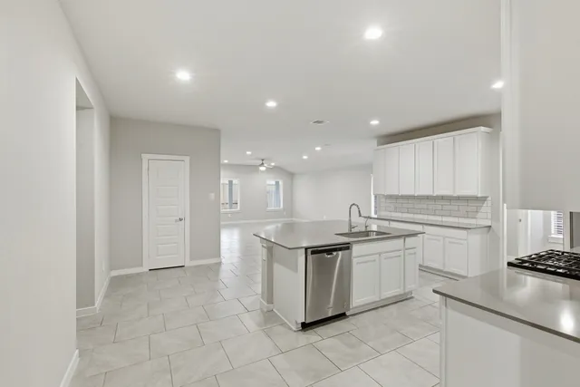 a kitchen with stainless steel appliances granite countertop a sink and cabinets