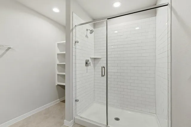 a bathroom with a shower and a sink