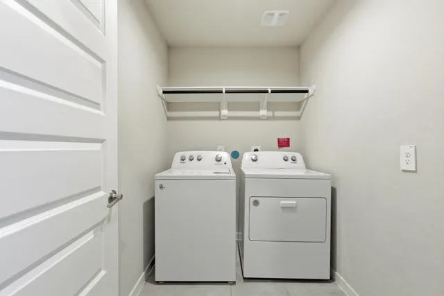 an empty room with cabinet and windows