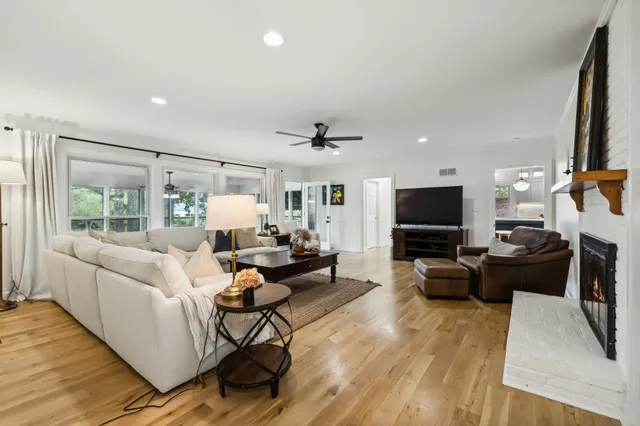 a living room with furniture a fireplace and a flat screen tv