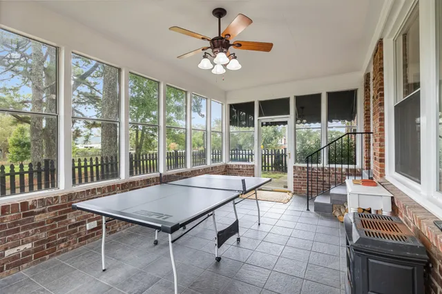 a view of a house with a small yard and a large tree