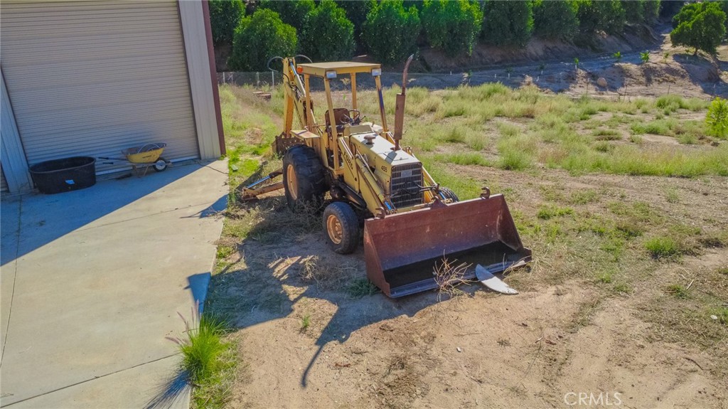 32265 Sapphire Street Mentone, CA 92359 - Photo 27 of 33 a view of a backyard with chairs and wooden fence