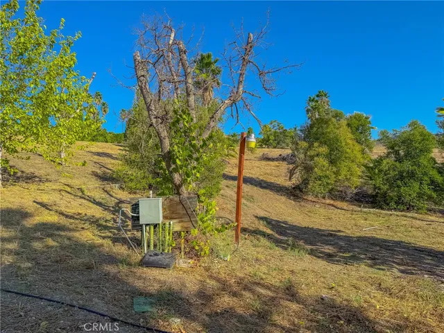 a view of a yard with wooden fence