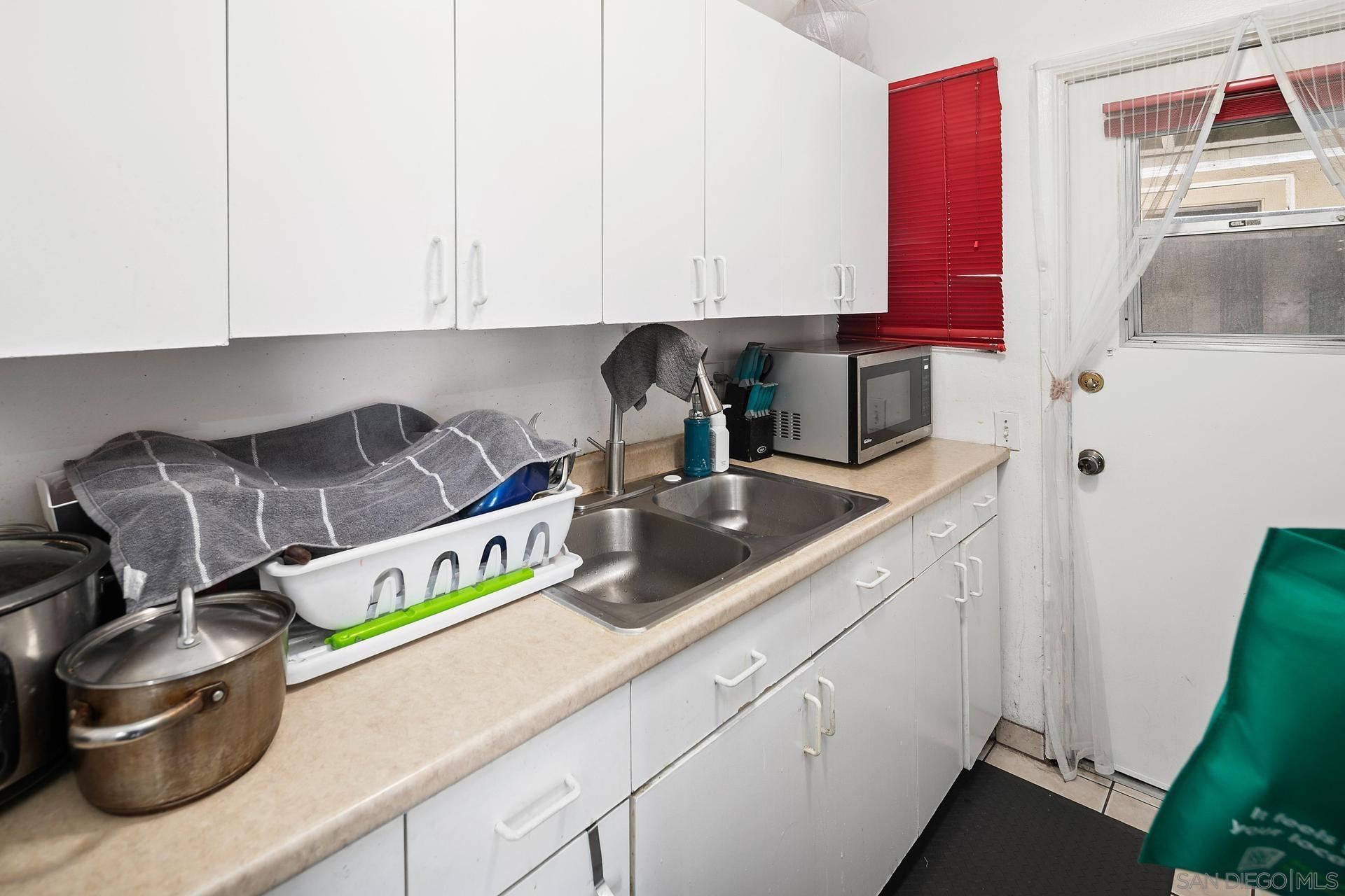 563 Madrona Street Chula Vista, CA 91910 - Photo 12 of 41 a kitchen with a sink and cabinets
