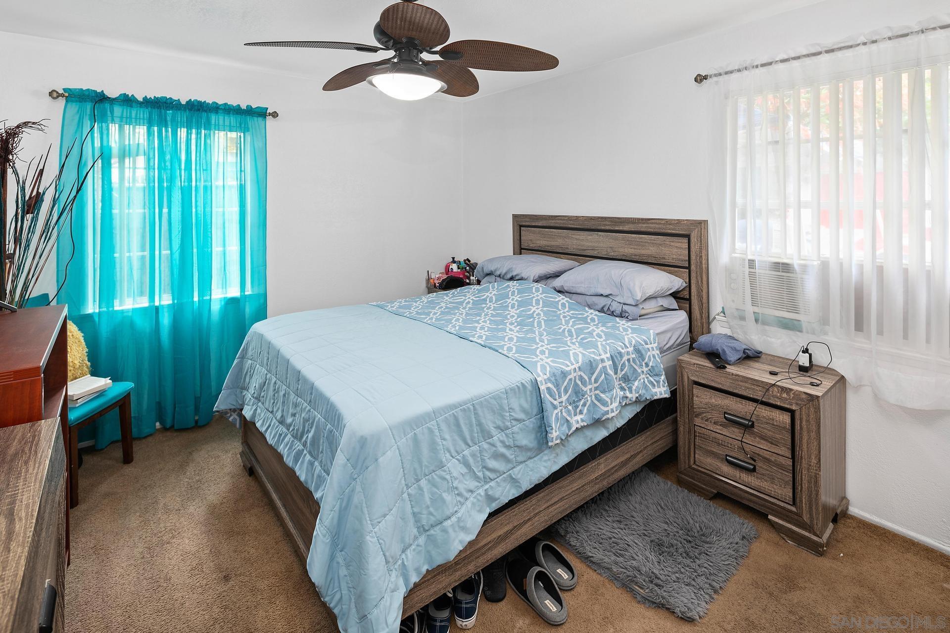 563 Madrona Street Chula Vista, CA 91910 - Photo 13 of 41 a bedroom with a bed and a chandelier