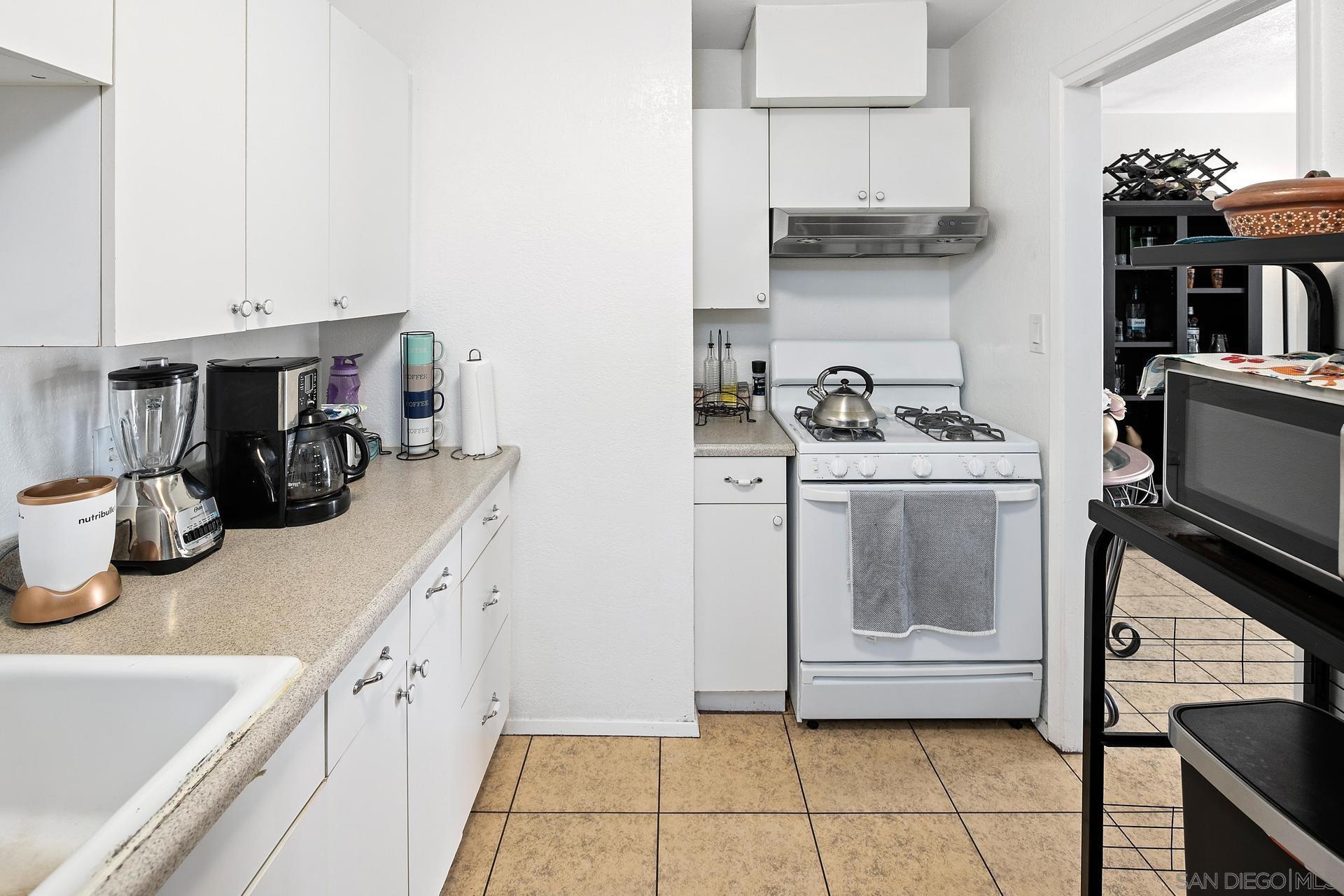 563 Madrona Street Chula Vista, CA 91910 - Photo 28 of 41 a kitchen with a sink and cabinets