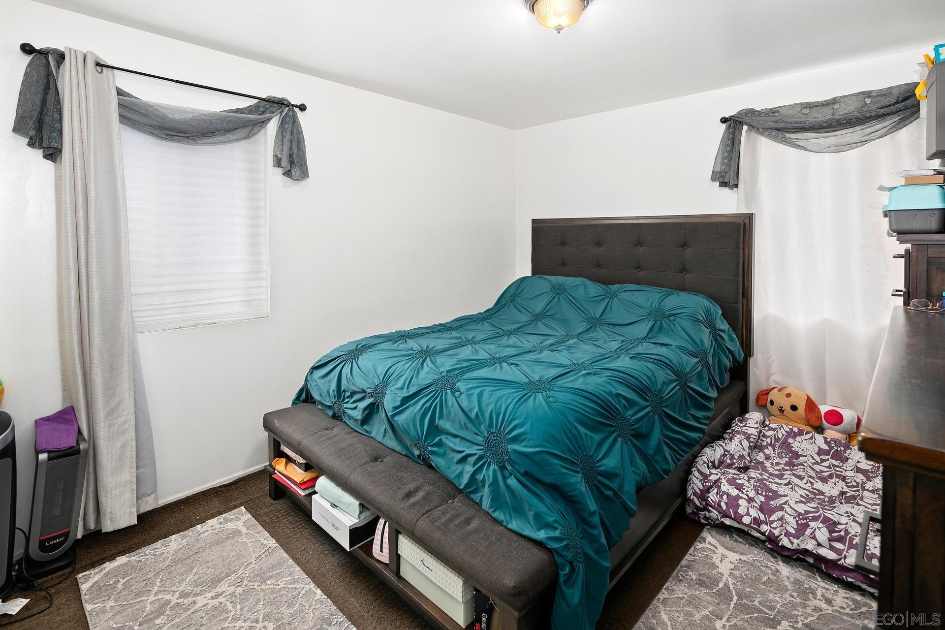 563 Madrona Street Chula Vista, CA 91910 - Photo 30 of 41 a bed room with a bed and a window