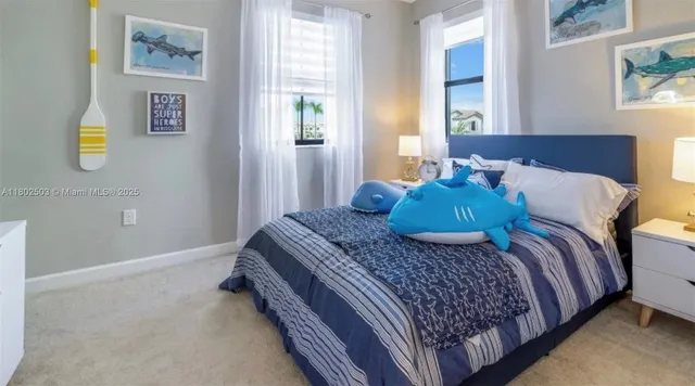 a bed sitting in a bedroom next to a window