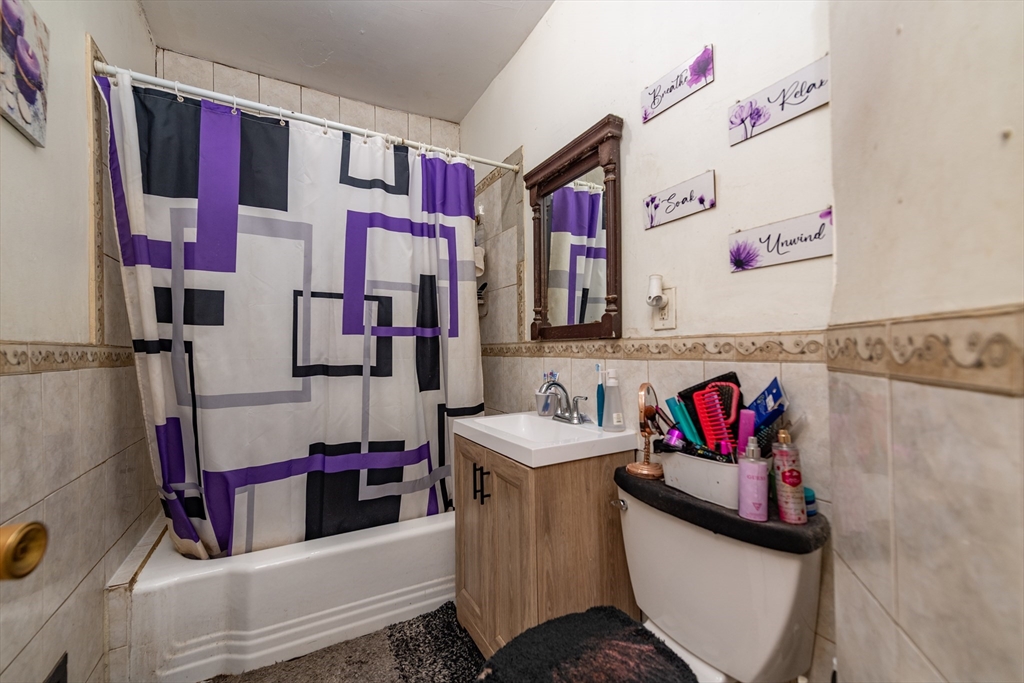 18 Santuit Street Boston, MA 02124 - Photo 13 of 17 a bathroom with sink mirror and vanity