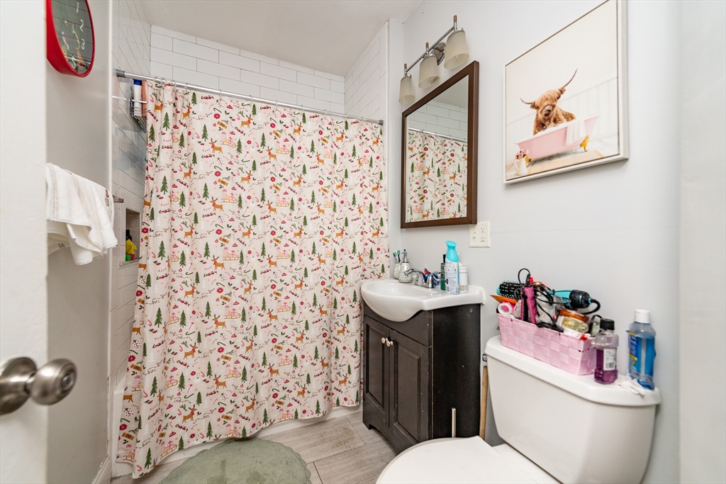 18 Santuit Street Boston, MA 02124 - Photo 17 of 17 a bathroom with a sink a toilet and a shower curtain
