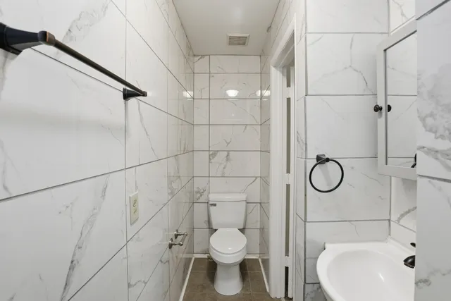 a bathroom with a toilet and a sink