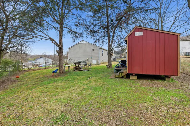 a view of backyard with huge green area and large trees