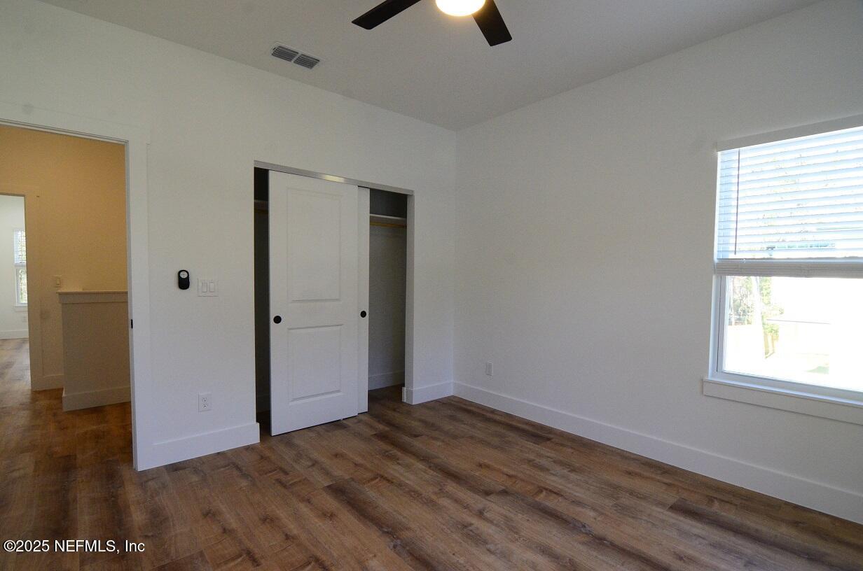 12724 Danbrook Street Jacksonville, FL 32223 - Photo 17 of 42 wooden floor in an empty room with a window