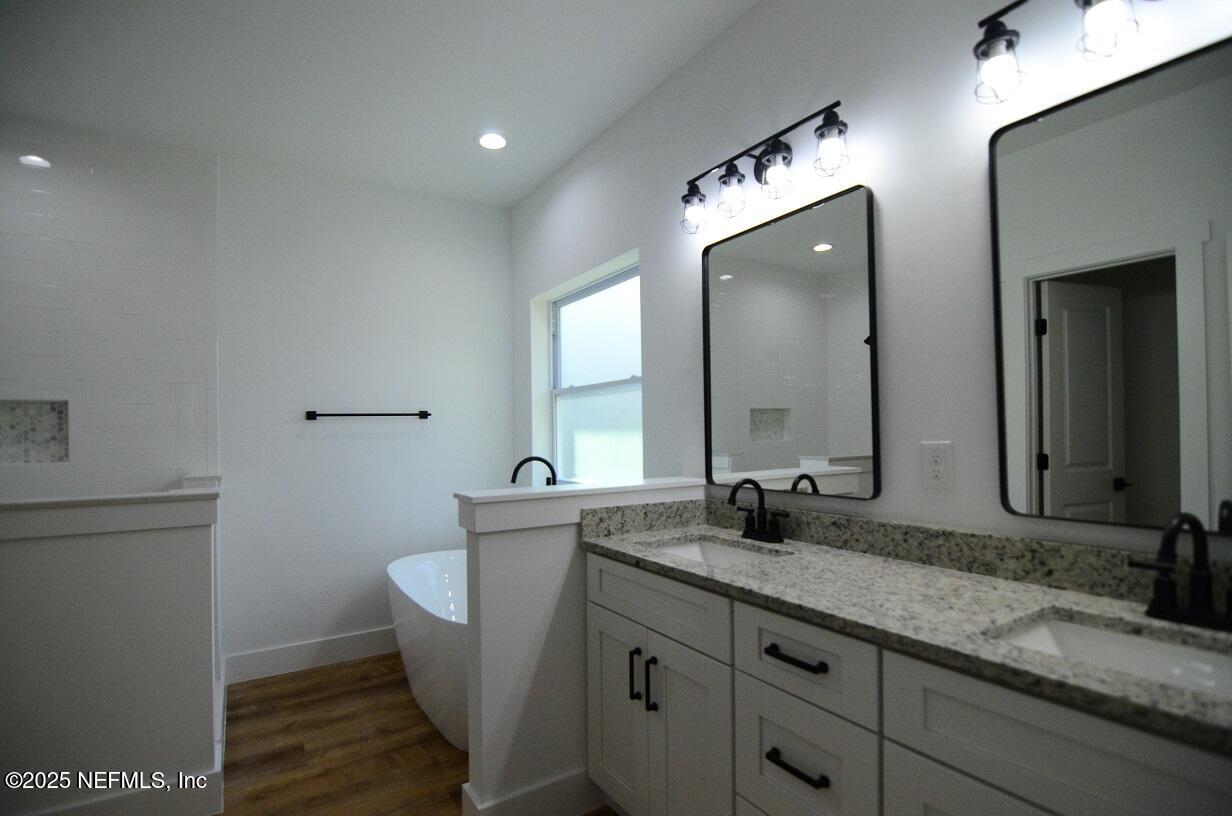 12724 Danbrook Street Jacksonville, FL 32223 - Photo 24 of 42 a bathroom with a double vanity sink and mirror