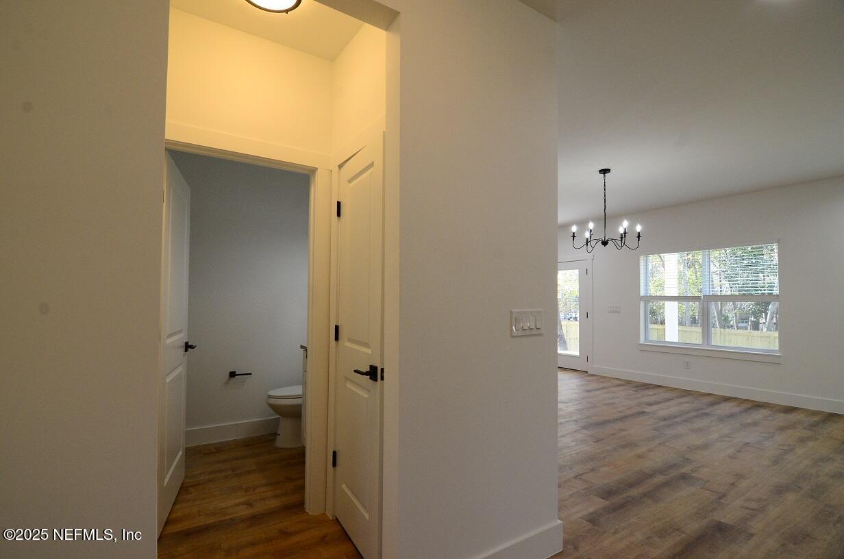 12724 Danbrook Street Jacksonville, FL 32223 - Photo 6 of 42 a view of an empty room with wooden floor and a window