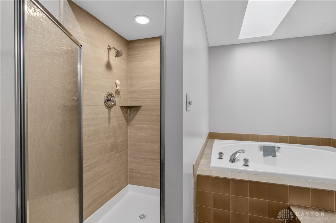 2165 Stewart Road Xenia, OH 45385 - Photo 37 of 59 Relax and refresh in this tranquil bathroom, offering both a shower and a soaking tub.