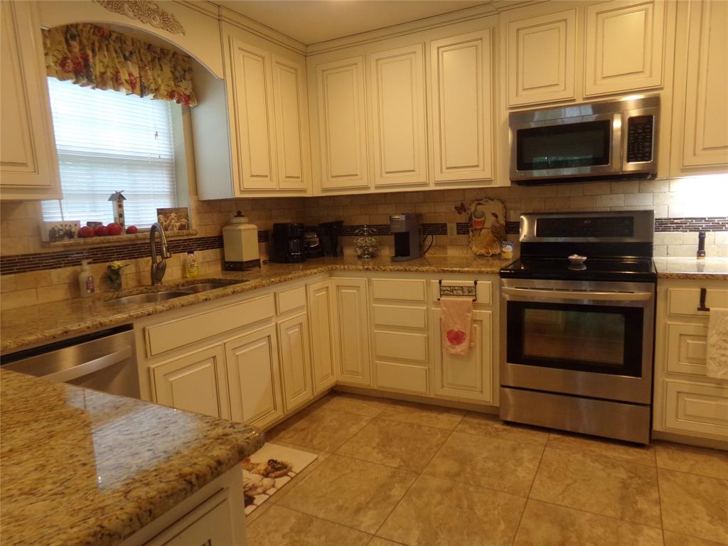 5110 Wedgefield Road Granbury, TX 76049 - Photo 15 of 23 Kitchen with cream-colored cabinetry, granite countertops, and tile flooring