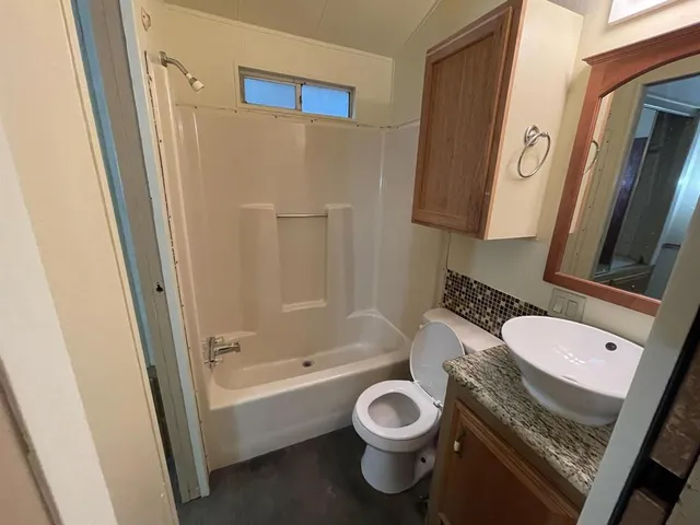 a bathroom with a shower and toilet