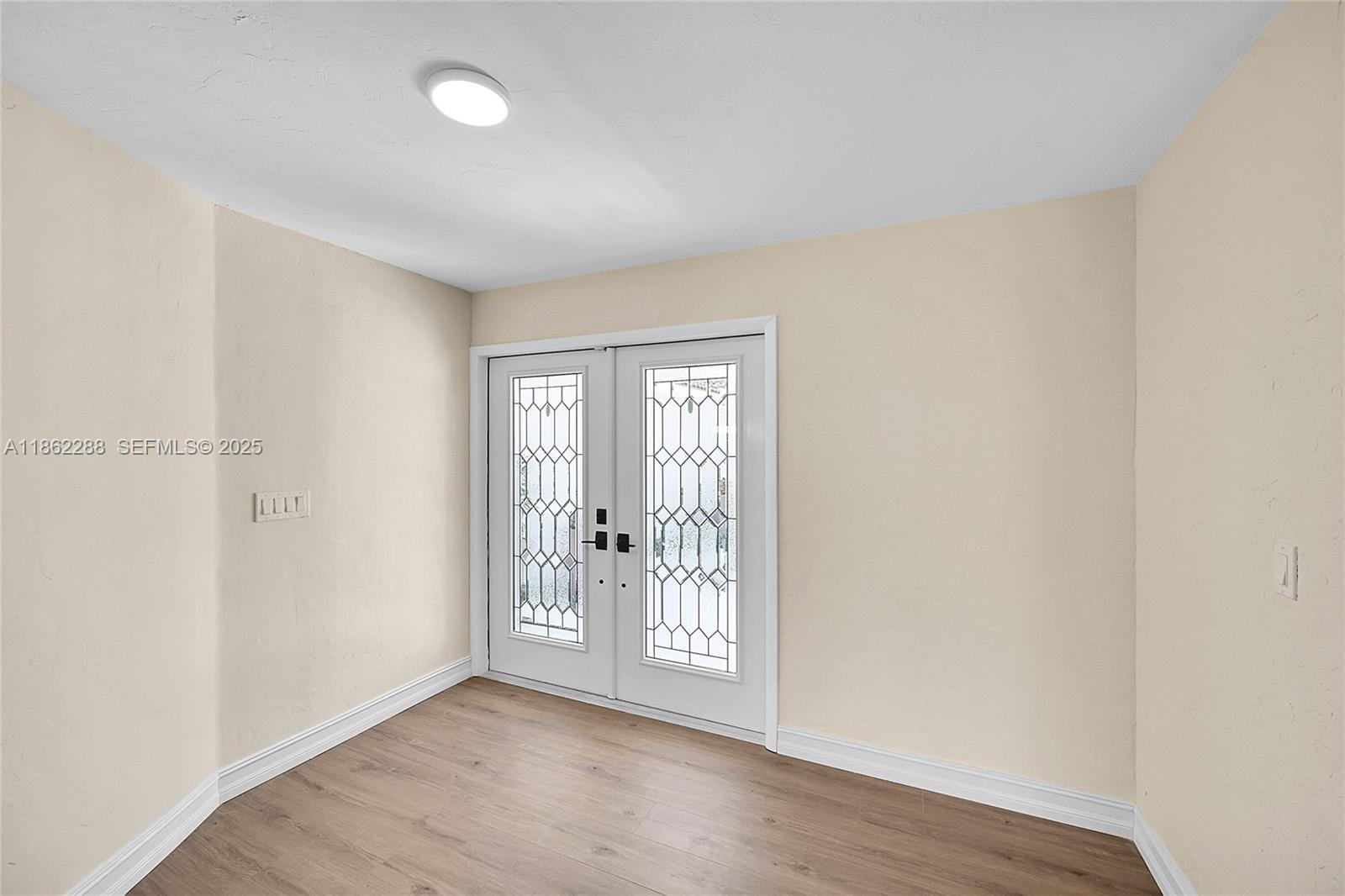 524 Muirfield Drive Atlantis, FL 33462 - Photo 11 of 55 an empty room with wooden floor and windows