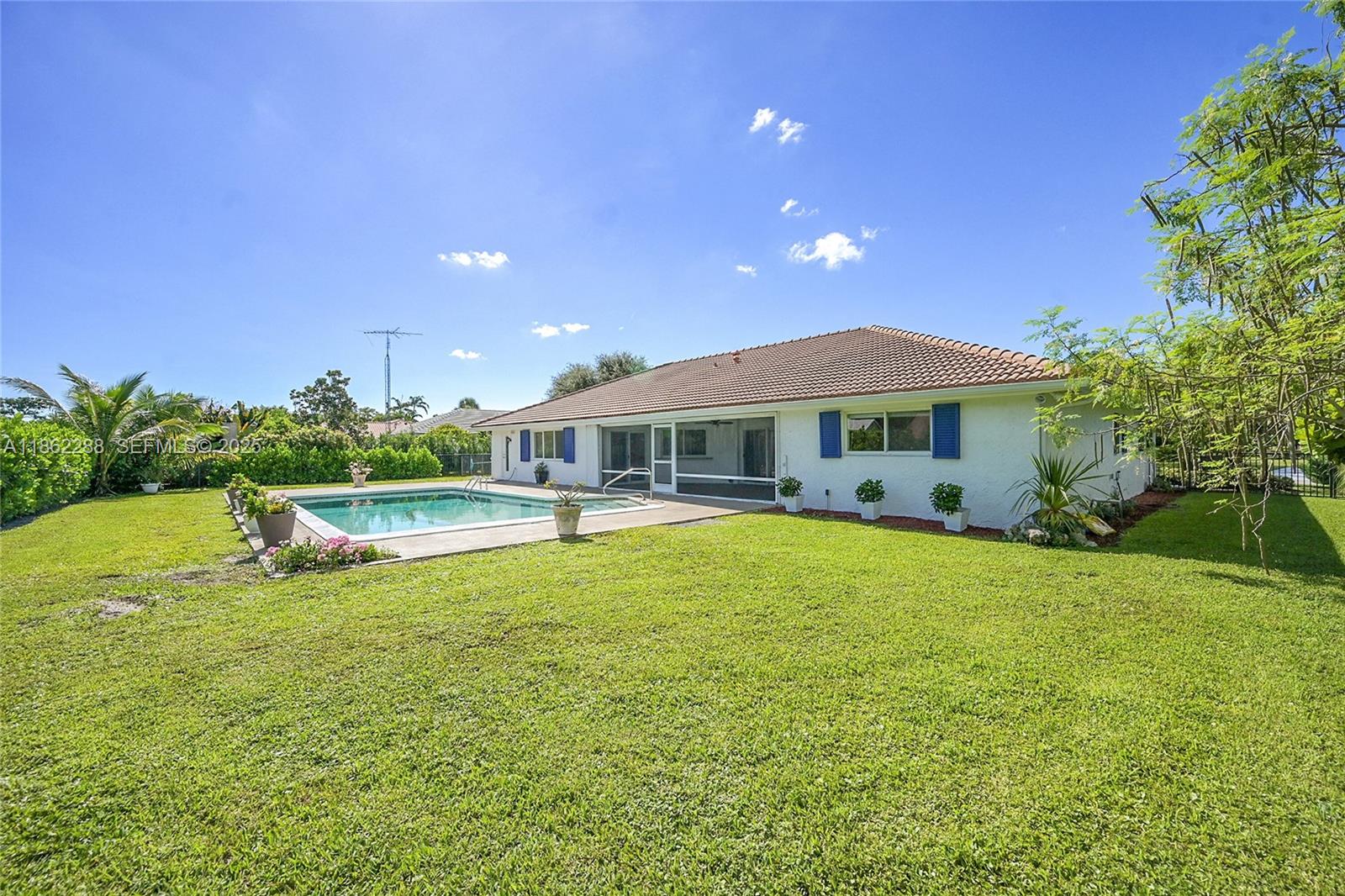 524 Muirfield Drive Atlantis, FL 33462 - Photo 44 of 55 a view of a house with swimming pool and a yard