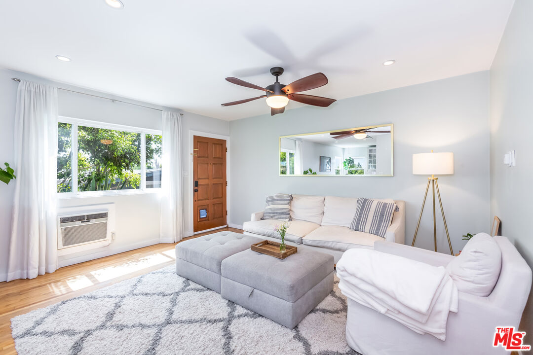 1835 7th Street, Unit D Santa Monica, CA 90401 - Photo 3 of 9 a living room with furniture and a large window