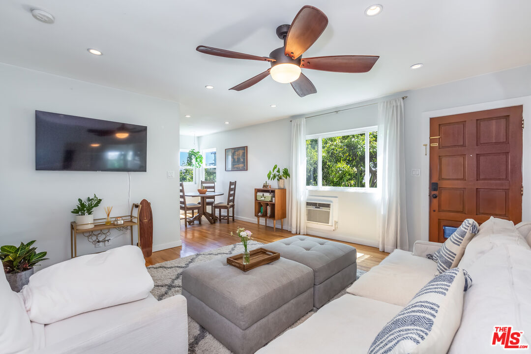 1835 7th Street, Unit D Santa Monica, CA 90401 - Photo 4 of 9 a living room with furniture and a flat screen tv
