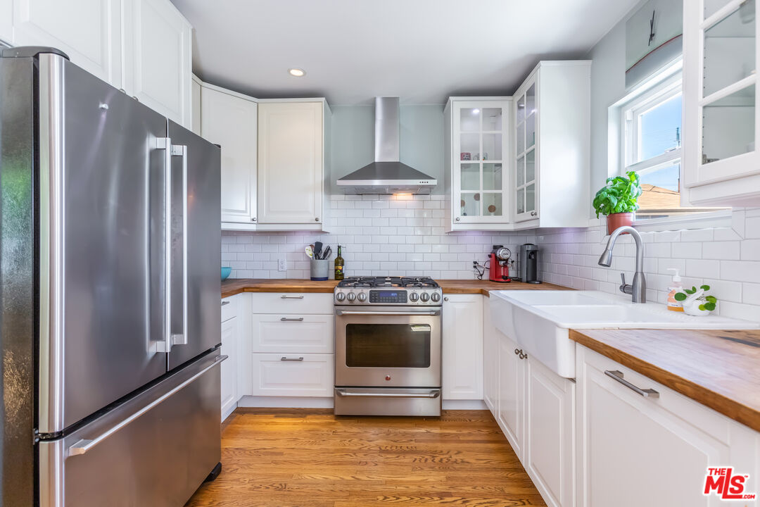 1835 7th Street, Unit D Santa Monica, CA 90401 - Photo 5 of 9 a kitchen with stainless steel appliances a stove a sink and a refrigerator
