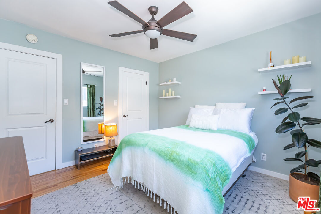 1835 7th Street, Unit D Santa Monica, CA 90401 - Photo 7 of 9 a bedroom with a bed and a chandelier