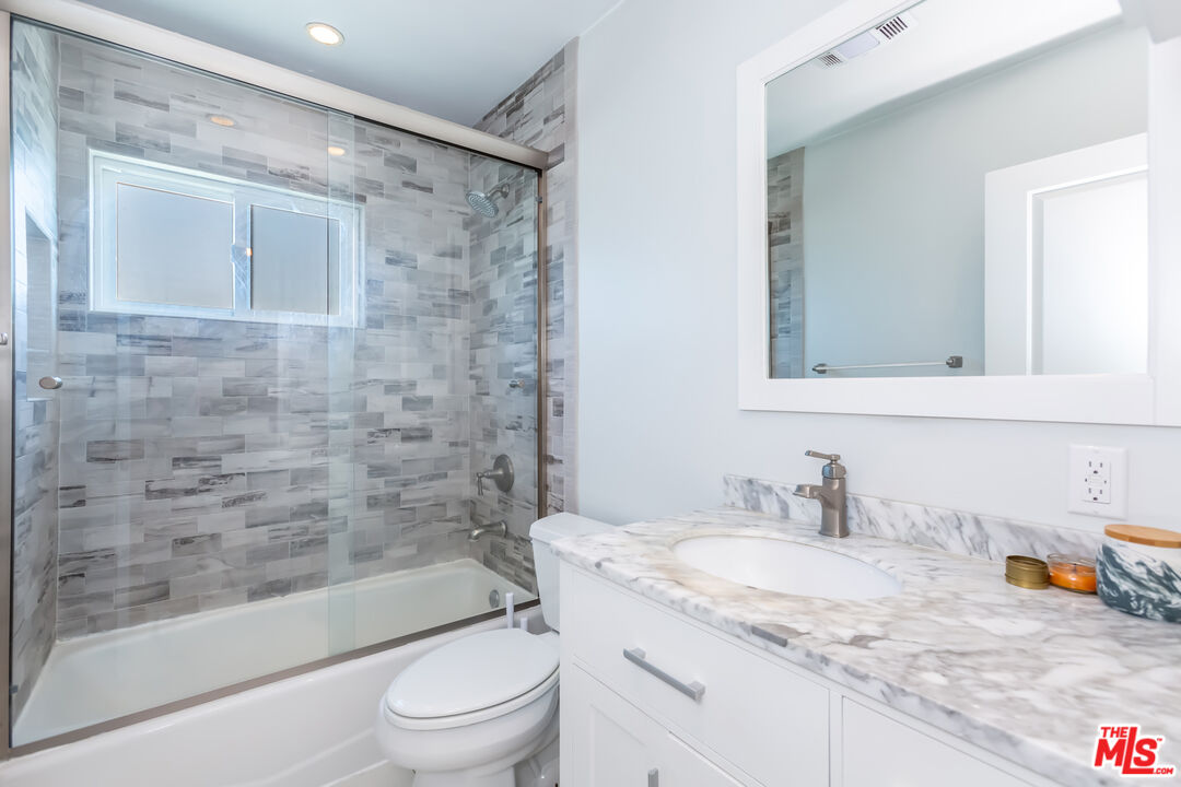 1835 7th Street, Unit D Santa Monica, CA 90401 - Photo 9 of 9 a bathroom with a granite countertop sink toilet and shower