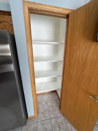 a view of walk in closet with empty racks