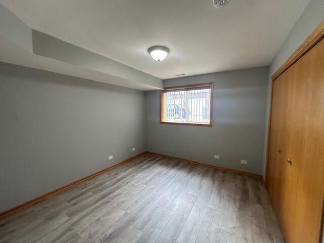 9924 Lands End Munster, IN 46321 - Photo 22 of 42 a view of an empty room with wooden floor and a window