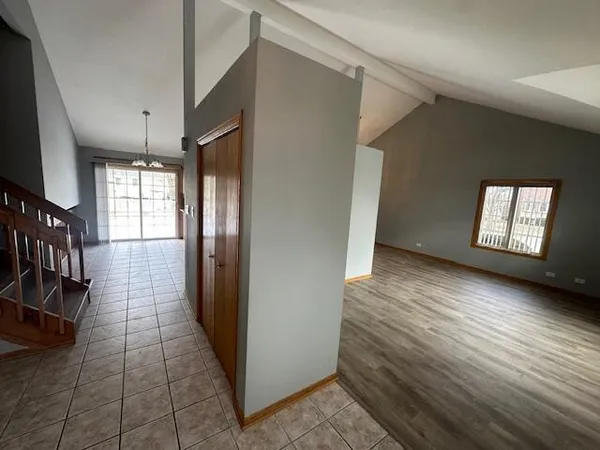 a view of hallway with stairs and wooden floor