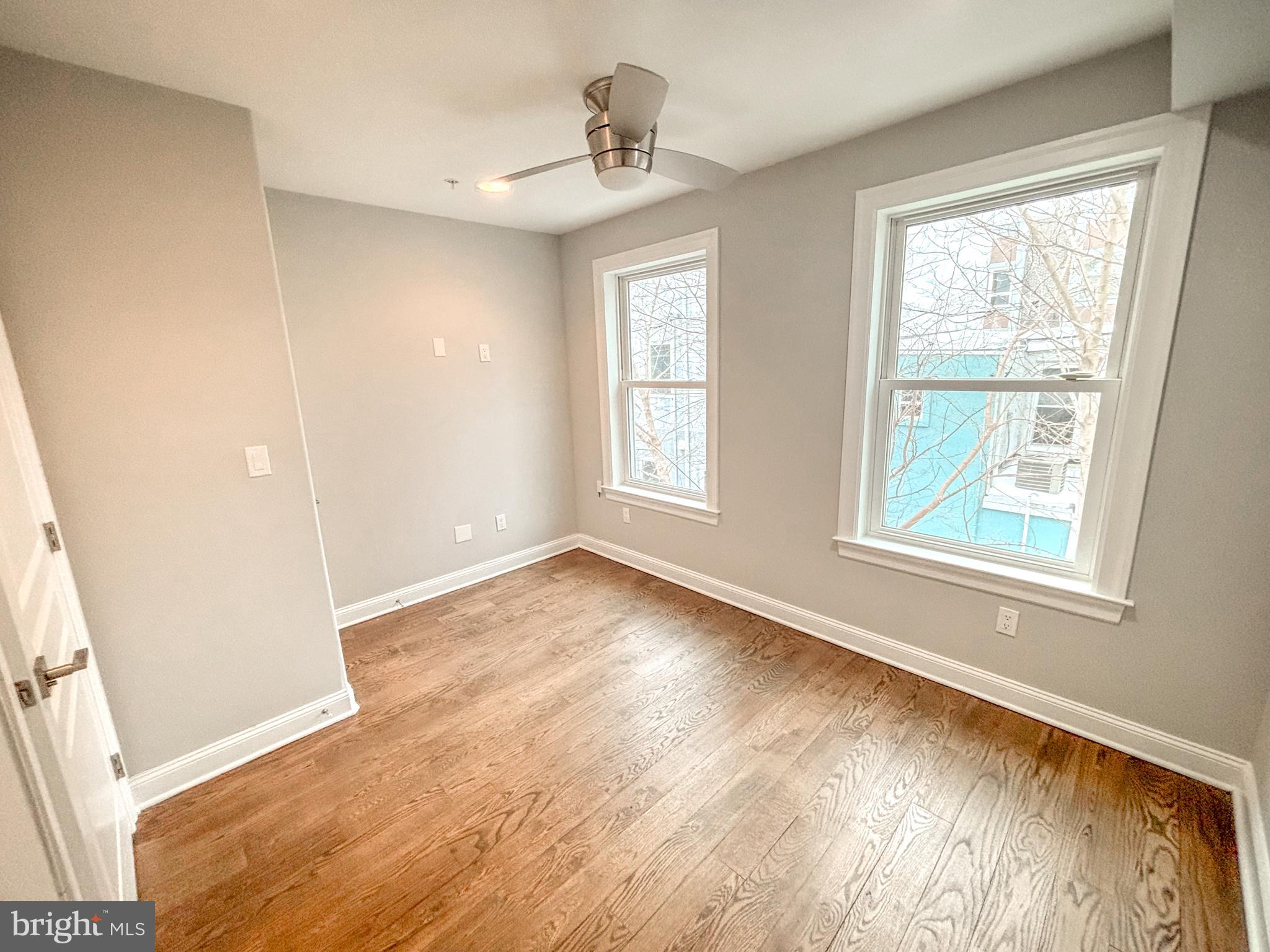 1526 South Cleveland Street Philadelphia, PA 19146 - Photo 14 of 30 an empty room with wooden floor and windows