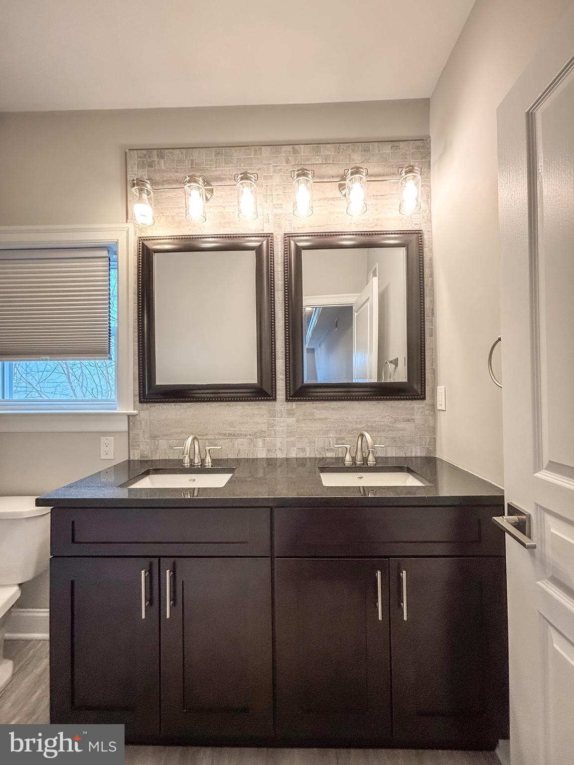 1526 South Cleveland Street Philadelphia, PA 19146 - Photo 21 of 30 a bathroom with a double vanity sink and mirror