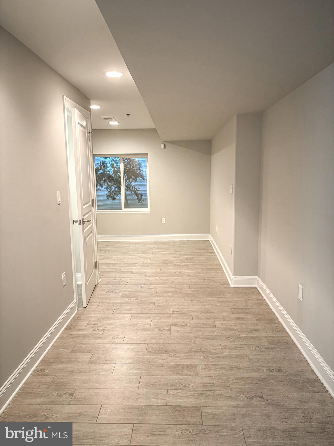 1526 South Cleveland Street Philadelphia, PA 19146 - Photo 23 of 30 wooden floor in an empty room with a window