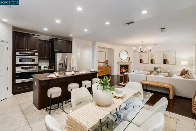a living room with kitchen island furniture and a chandelier