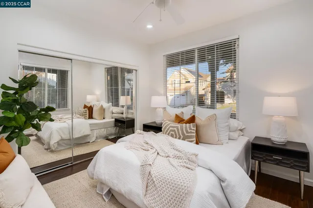 a bedroom with a large bed and a large window