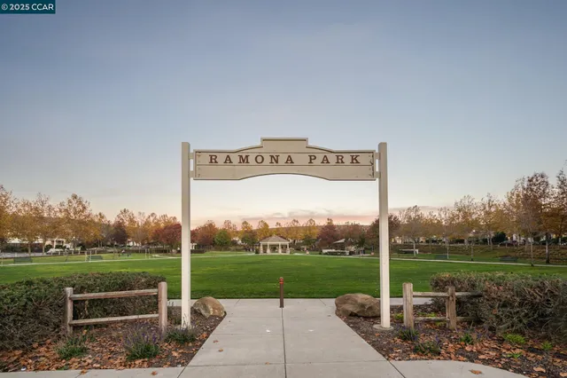 a view of a house with garden yard and sitting area