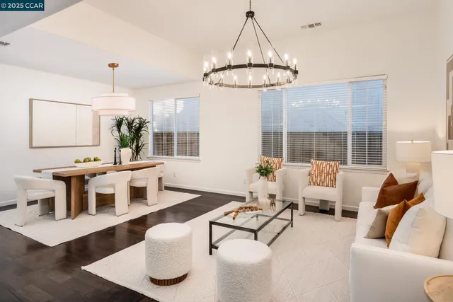 a living room with furniture a chandelier and a chandelier