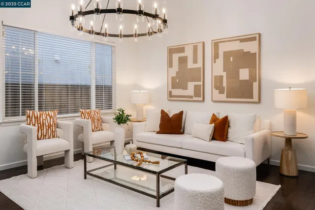 a living room with furniture a lamp and a table