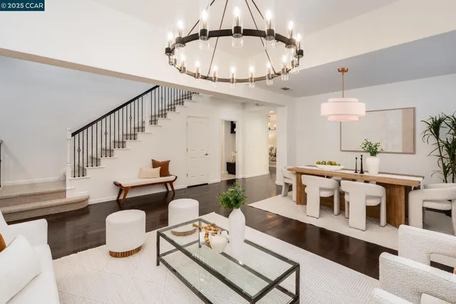 a living room with furniture a chandelier and a chandelier