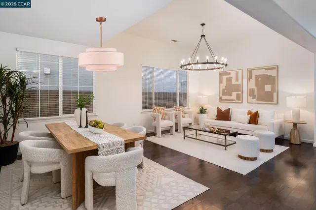 a living room with furniture chandelier and a chandelier