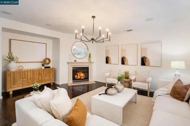 a living room with furniture a clock and a fireplace